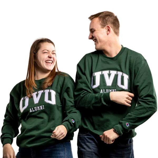 A man and woman modeling the crewneck sweatshirt, Champion logo applicate on bottom left sleeve